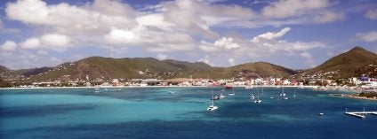 boats in the harbor by the coast of towns