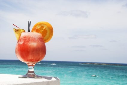 tequila sunrise with a view of the Caribbean Sea