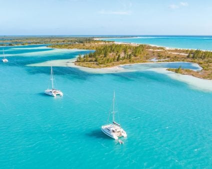 charter anchorage with boats by beach for sustainable sailing